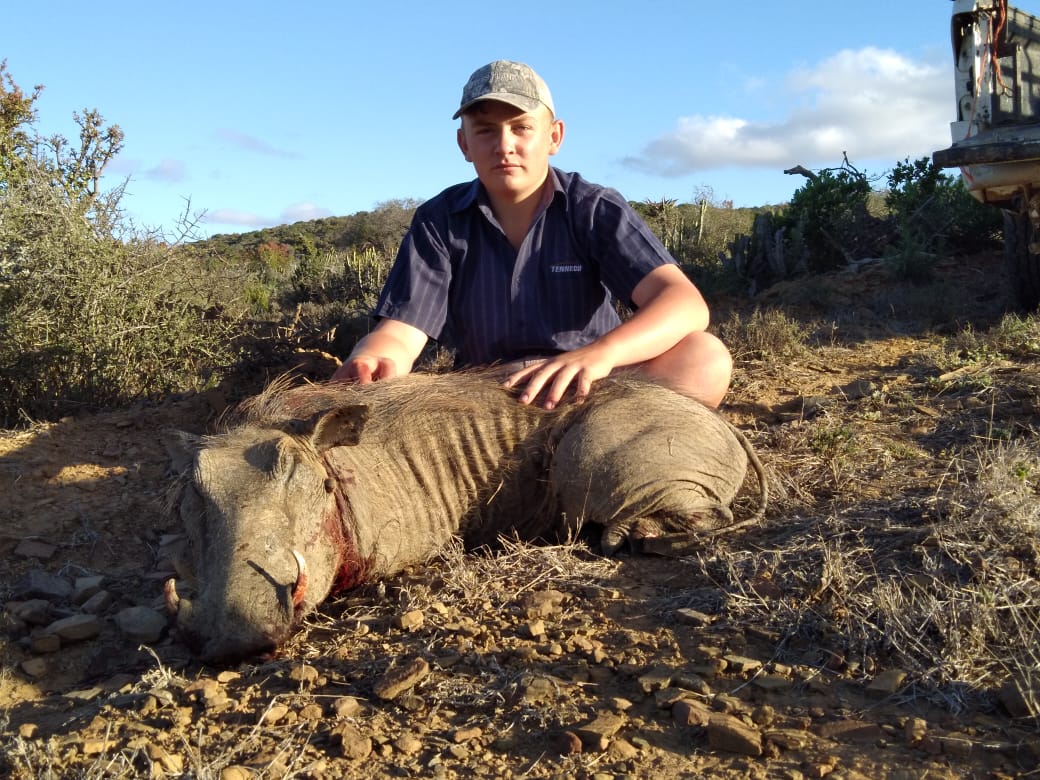 Our son Mark, with a warthog